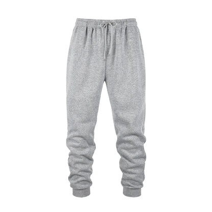 Men's gray fleece jogger sweatpants in soft polyester fabric with an elastic waistband and tapered cuffs. Designed for movement with moisture-wicking performance, ideal for workouts, lounging, or everyday wear.
