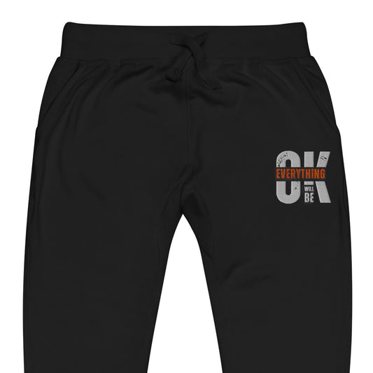 Black unisex fleece sweatpants with ribbed waistband, cuffed ankles, and front cross pockets. Shown flat to highlight the 5-thread stitching and soft fleece lining.