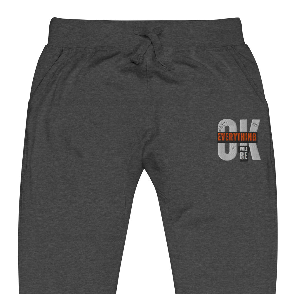 Gray unisex fleece sweatpants with ribbed waistband, cuffed ankles, and front cross pockets. Shown flat to highlight the 5-thread stitching and soft fleece lining. 