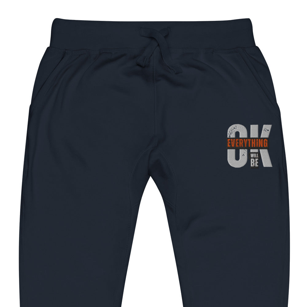 Navy blue unisex fleece sweatpants with ribbed waistband, cuffed ankles, and front cross pockets. Shown flat to highlight the 5-thread stitching and soft fleece lining.
