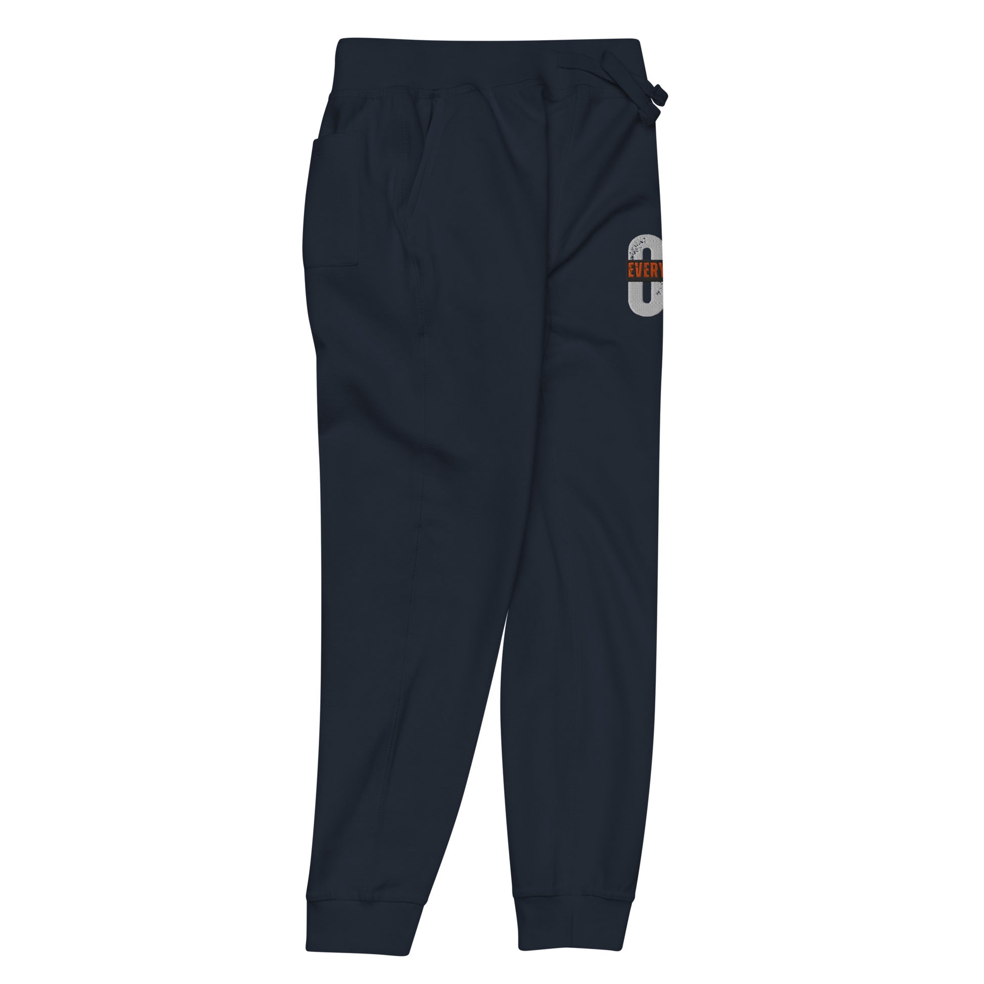 Navy blue unisex fleece sweatpants with ribbed waistband, cuffed ankles, and front cross pockets. Shown flat to highlight the 5-thread stitching and soft fleece lining.
