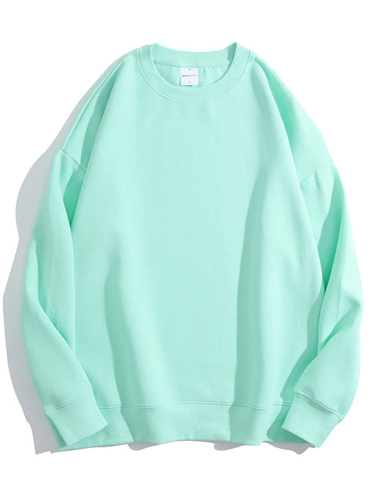An oversized women’s sweatshirt in mint, with a perfectly slouchy silhouette and extra-long sleeves designed for cuffing over hands. The thick, cloud-soft organic cotton fabric drapes in effortless folds, while ribbed cuffs and hem add subtle structure. A lived-in, cozy essential that looks better with every wear.