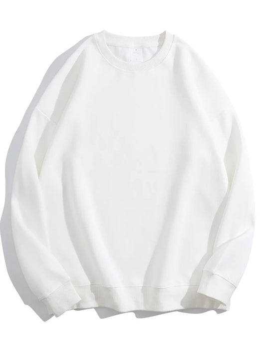 An oversized women’s sweatshirt in white, with a perfectly slouchy silhouette and extra-long sleeves designed for cuffing over hands. The thick, cloud-soft organic cotton fabric drapes in effortless folds, while ribbed cuffs and hem add subtle structure. A lived-in, cozy essential that looks better with every wear.