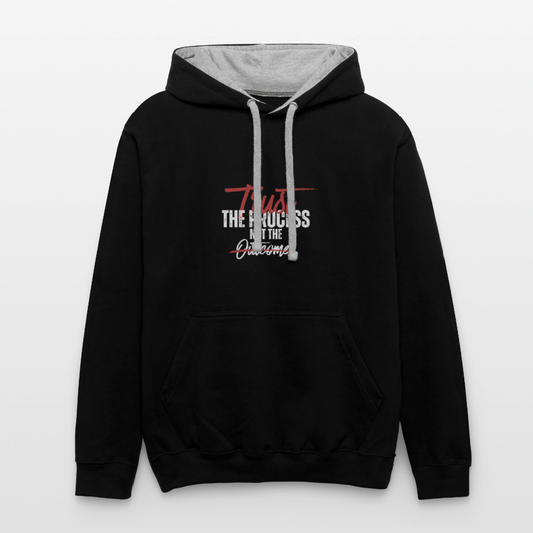 A unisex black/gray contrast hoodie featuring a double-layered hood with a bold contrasting inner fabric and matching flat lace drawcords. The front displays a motivational print reading "Trust the Process Not the Outcome" in a clean, modern font. Made from a soft 80% cotton/20% polyester blend (8.3 oz midweight fabric), it has ribbed cuffs and hem for a snug fit. Designed for tag-free comfort with a tear-out label, this stylish pullover by ADON LUXE is perfect for everyday wear. 