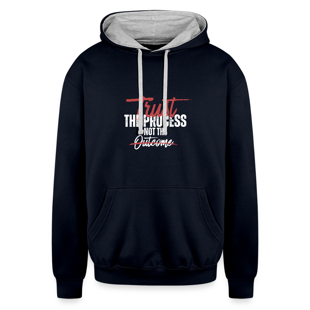 A unisex black/gray contrast hoodie featuring a double-layered hood with a bold contrasting inner fabric and matching flat lace drawcords. The front displays a motivational print reading "Trust the Process Not the Outcome" in a clean, modern font. Made from a soft 80% cotton/20% polyester blend (8.3 oz midweight fabric), it has ribbed cuffs and hem for a snug fit. Designed for tag-free comfort with a tear-out label, this stylish pullover by ADON LUXE is perfect for everyday wear. 