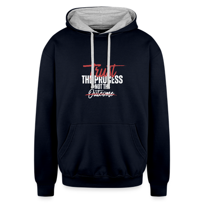 A unisex black/gray contrast hoodie featuring a double-layered hood with a bold contrasting inner fabric and matching flat lace drawcords. The front displays a motivational print reading "Trust the Process Not the Outcome" in a clean, modern font. Made from a soft 80% cotton/20% polyester blend (8.3 oz midweight fabric), it has ribbed cuffs and hem for a snug fit. Designed for tag-free comfort with a tear-out label, this stylish pullover by ADON LUXE is perfect for everyday wear. 
