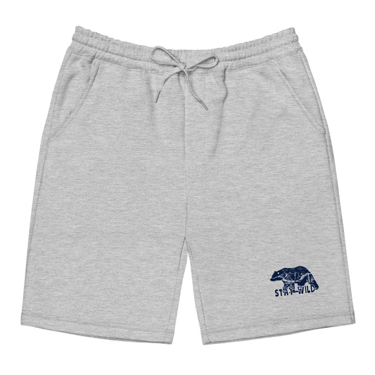Men's gray fleece lounge shorts with elastic drawstring waist, jersey-lined pockets, and tapered knee opening, shown flat to highlight sewn fly detail.